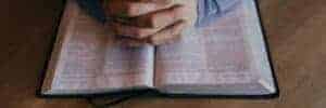 Hands on open Bible