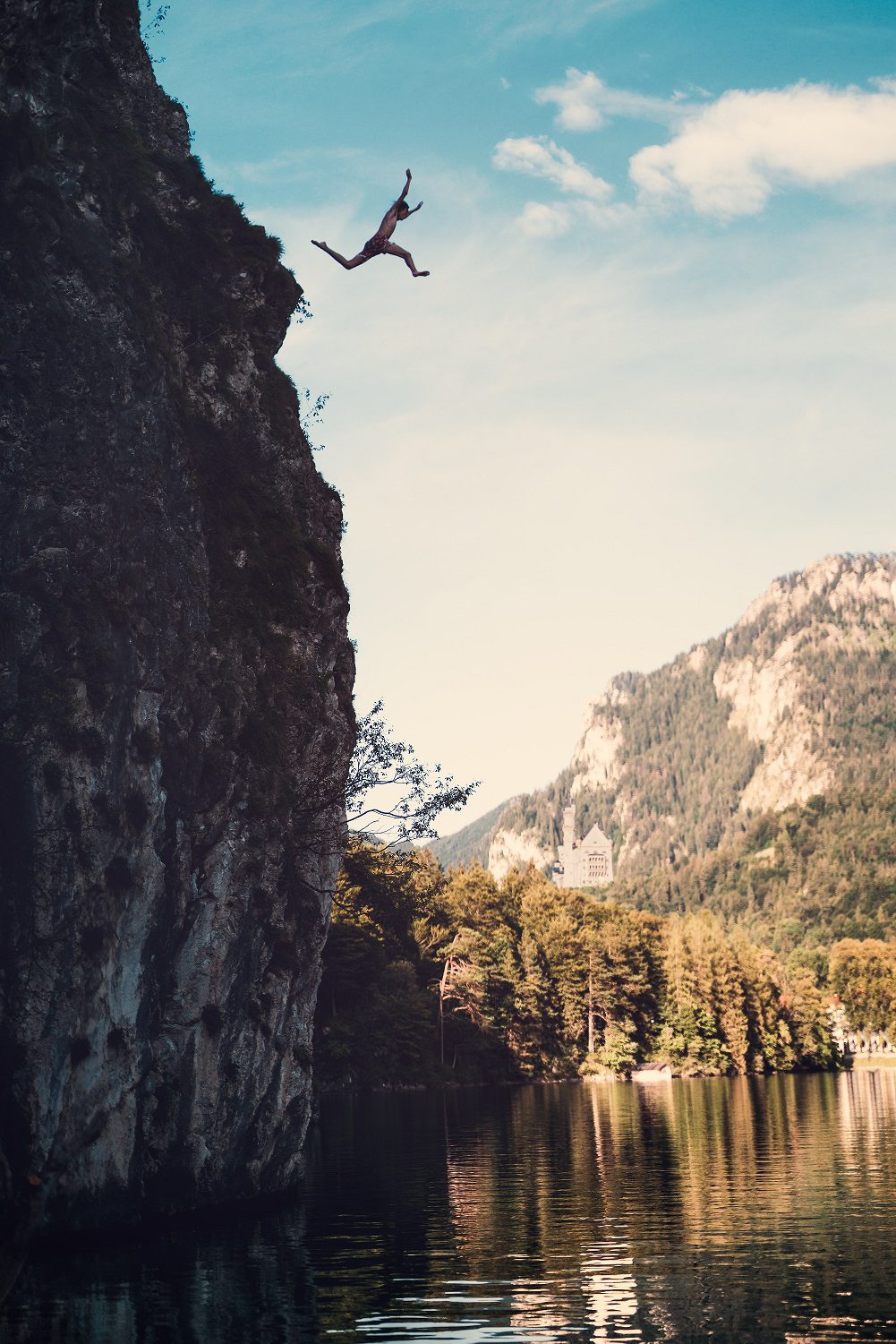 Man jumping off sheer cliff