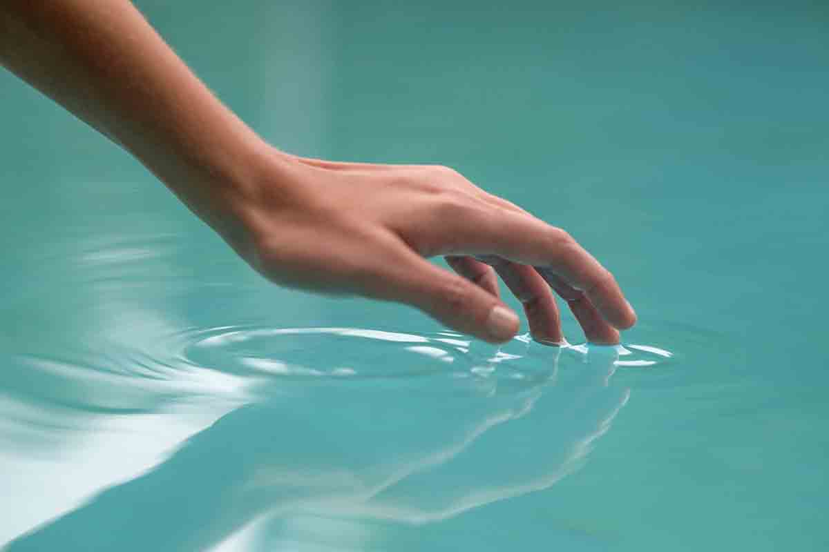 hand touching water